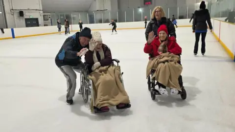 Care home residents enjoying a trip to an ice rink