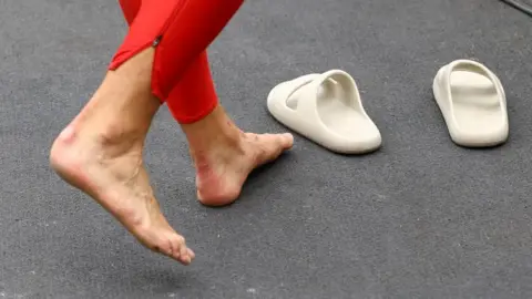 Reuters Bare feet walking
