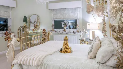 Kirsty Anderson Bedroom decorated with an array of white and gold ornaments and Christmas decorations.