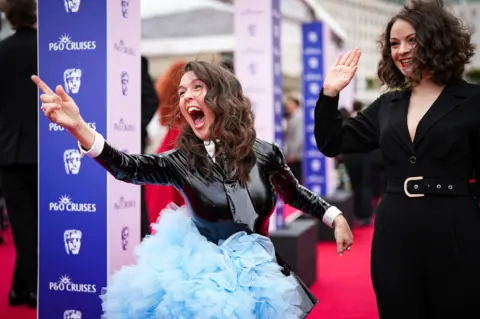 Getty Images Rosie Jones smiling and pointing, wearing a blue tutu