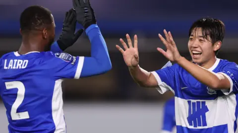 Ayumu Yokoyama (right) celebrates his goal against Swindon