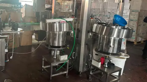 Bolton Council Large metal bowls, vats and machines in a brick building.