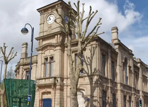 City of Wolverhampton Council 1800's light coloured stone building with trees into front of it 