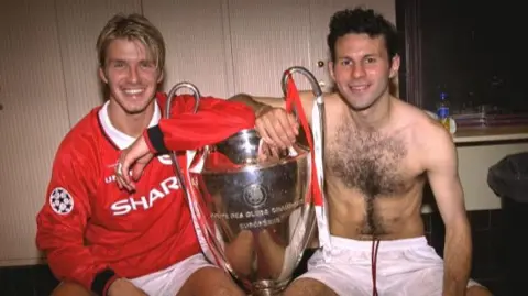 David Beckham and Ryan Giggs with the European Cup between them in the dressing room in 1999