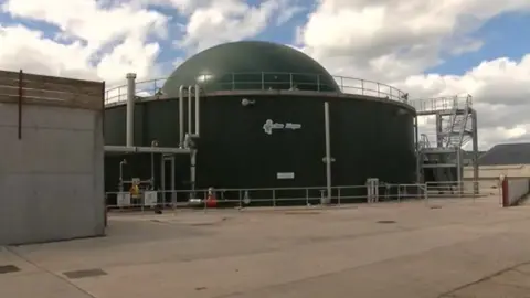 Matthew Murray/BBC An anaerobic digester which is a large metal structure with a sphere on the top. It is used for food to break down in and store gas. It's a metal painted green structure