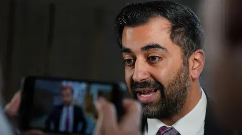 PA Images Humza Yousaf faces journalists in Holyrood