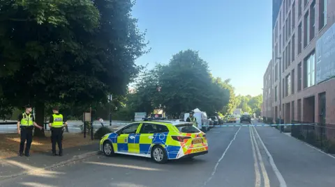 A number of police officers in a street