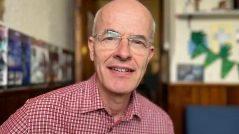 Emma Baugh/BBC Reverend Giles Knight