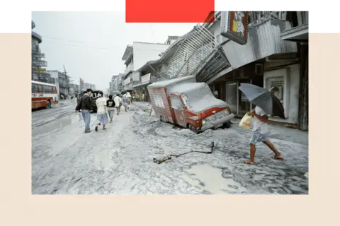 Getty Images People walk through the ash in the wake of the volcano erupting