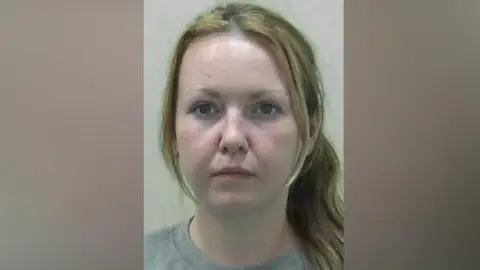 Mugshot of Lawson. She has long blonde hair tied back in a ponytail.