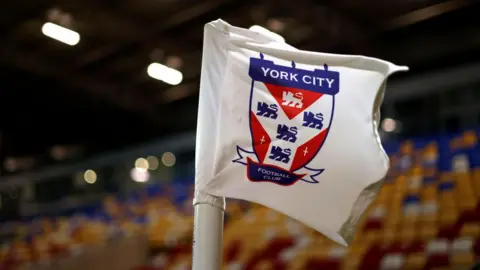 Getty Images A York City Football Club flag inside a stadium, with empty seats behind it.