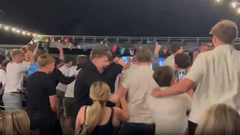 Fans celebrating as England's Harry Kane scored a penalty