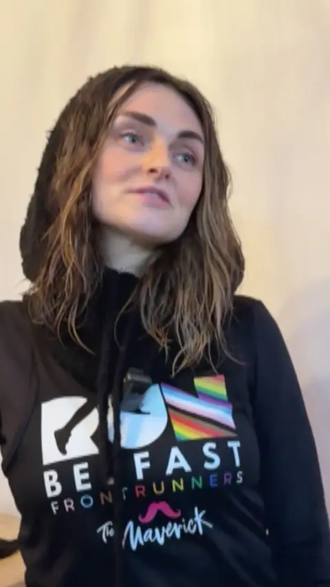 Charlene Hegarty has shoulder length brown hair and is wearing a black hoodie