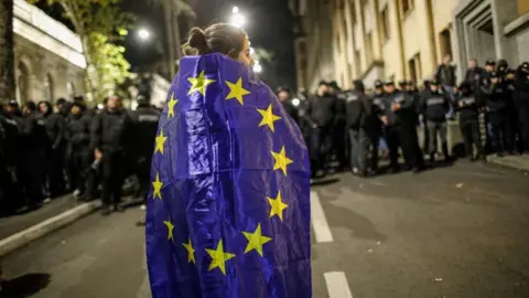 A supporter of opposition parties wears a European Union (EU) flag during a protest in Tbilisi, Georgia, 28 October 2024