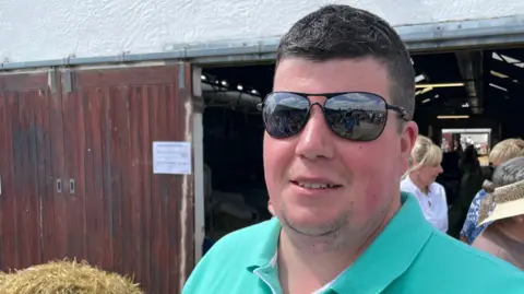 Farmer Tom Mitchinson at the Great Yorkshire wearing a green polo shirt.