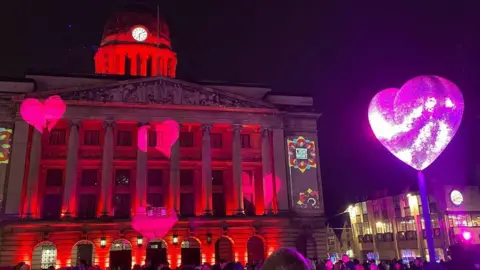 Isaac Ashe/BBC Nottingham's Council House lit up with hearts