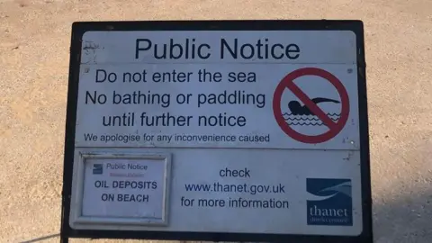 A sign indicating that people should not enter the sea, bathe or paddle until further notice at Palm Bay, Margate, Kent.