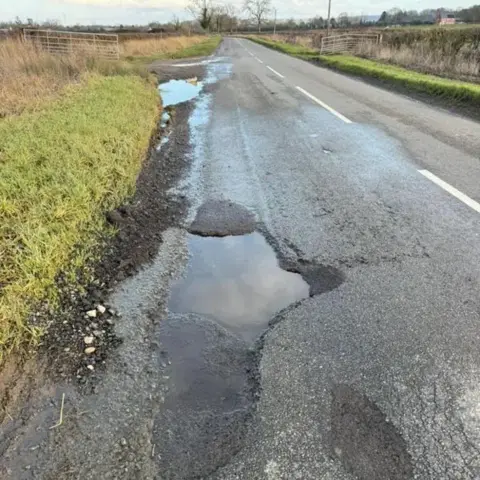 Peter Hortor A view of a pothole on the road between Kinoulton and Hickling, with the edge showing a newer tarmac which has come away in the middle.