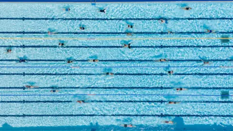 PA Media People swim at Banbury Lido at Woodgreen Leisure Centre in Oxfordshire.