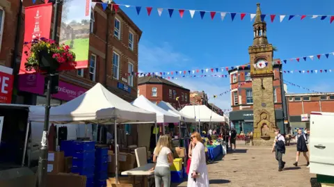 LDRS The centre of Ormskirk on market day with bunting, stalls and vans