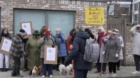 Group of people protesting and holding banners