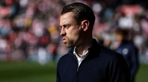 Tonda Eckert looks on from the sidelines
