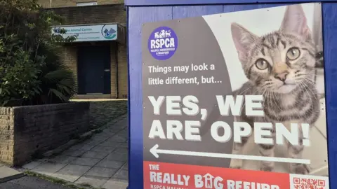 RSPCA The entrance to an animal shelter in Halifax with a large sign with a kitten on it stating the centre is open