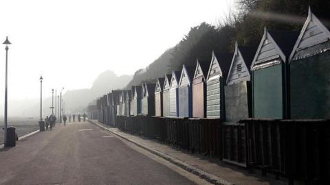 Row of Bournemouth beach huts by a promenade