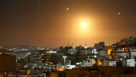 Many rockets, fired from Iran, are seen over Jerusalem from Hebron, West Bank on October 01, 2024. 