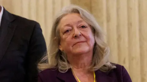 PA Media Patricia McKeown. She has long blonde hair, wearing a dark blazer.