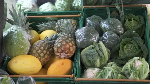 BBC Green crates containing brocolli, cabbages, cauliflowers, lettuce, pineapples and honeydew melons 