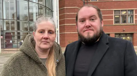 An image of BBC Sara and Gary Andrews stands outside the Nottingham Magistrate Court 