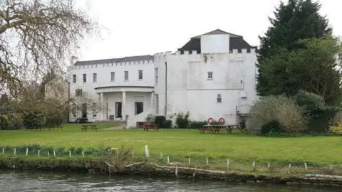 Chris Allen/ Geograph Bray studios white 18th century house sat next to a body of water and surrounded by green grass and trees