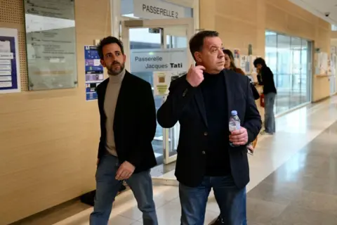 Getty Images Florian, the family's youngest sister (L), and her brother David in the corridor during the trial.