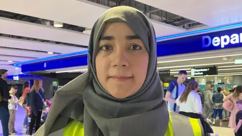 Shurma Chowdhury greeting pilgrims at Manchester Airport