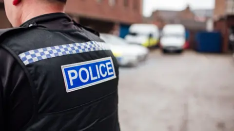 Staffordshire Police Police officer by cars