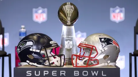 The Lombardi Trophy trophy along with helmets from the New England Patriots and Seattle Seahawks before Super Bowl 60