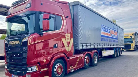 A Hawks branded lorry in a depot