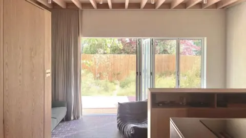 Will Howard Picture of the living space that opens up on to a garden that is seven metres long