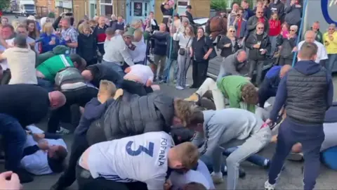 Men "scuffling" in a town centre