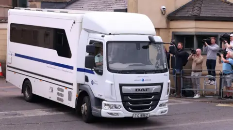 PA Media A white prison van carrying former DUP leader Sir Jeffrey Donaldson leaves Newry Crown Court
