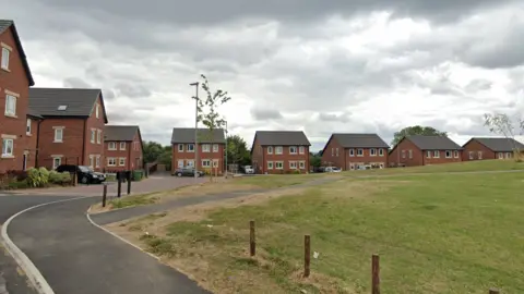 Monet Close in Chapel Allerton, a modern housing estate with green open space in the centre.