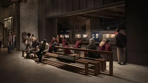 Secchi Smith People are sitting and standing on benches in a dimly lit indoor area of the general market, looking through a large window at a moving train on the platform outside