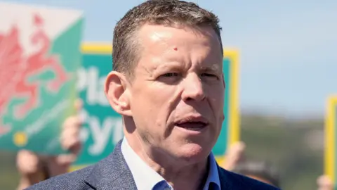 Rhun ap Iorwerth looking to the right of the picture