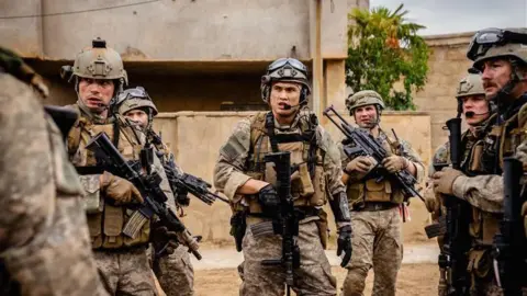 Murray Close A screenshot of the movie, showing Aaron Mackenzie and other actors in military uniforms holding guns.