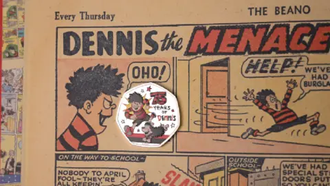 PA Media The new Dennis the Menace coin on one of the comic strips