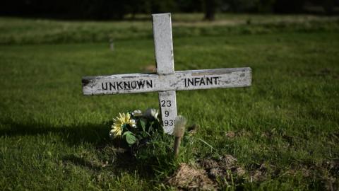 A headstone which reads unknown infant can be seen in the Bog Meadows area of Milltown cemetery which is home to unmarked mass graves and the bodies of children from so called Mother and Baby homes