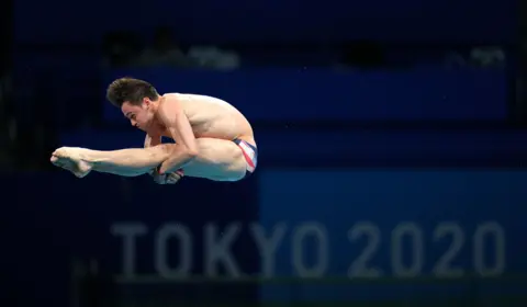 PA Media Tom Daley mid-dive