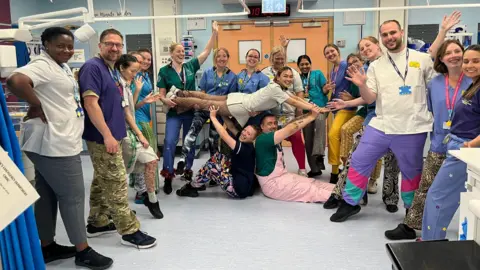 The Grand Appeal A large group of medical staff on a ward at the Bristol Children's Hospital pose in different types of trousers in aid of the Wallace and Gromit Grand Appeal
