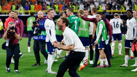 Gareth Southgate roars in celebration as player look on